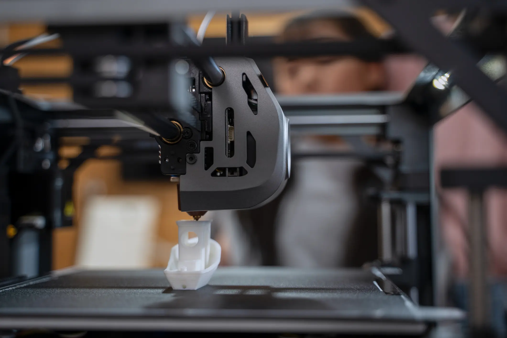 3D printer creating a small white object.