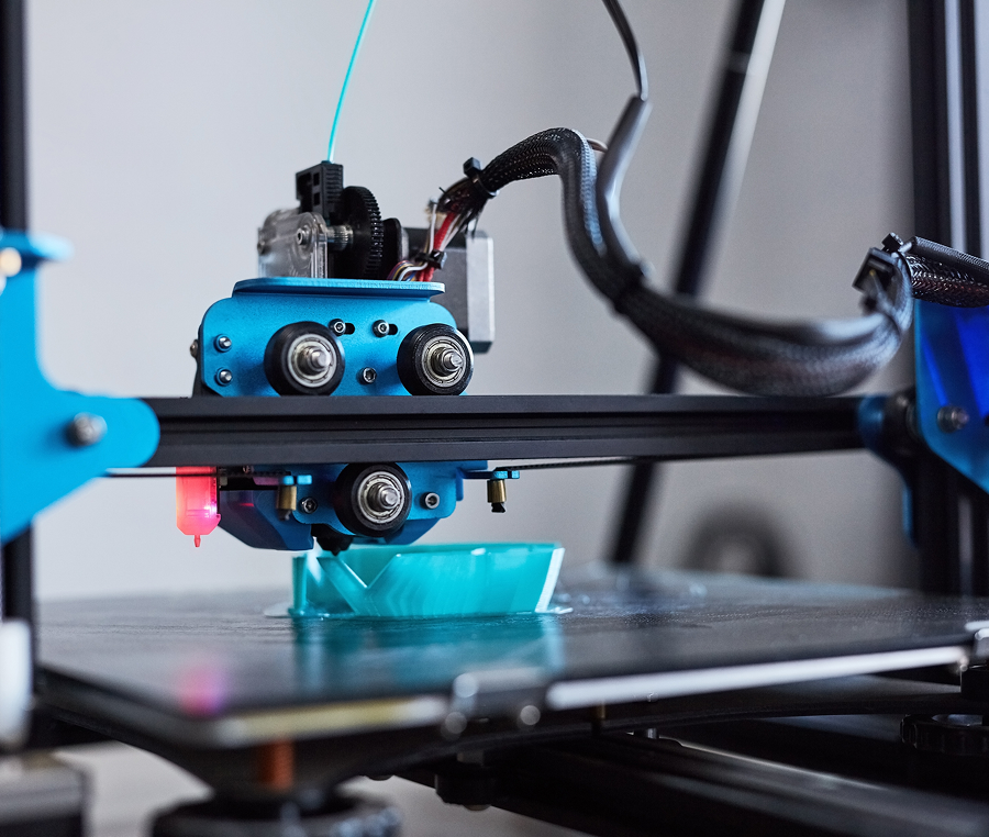 3D printer creating a blue object.