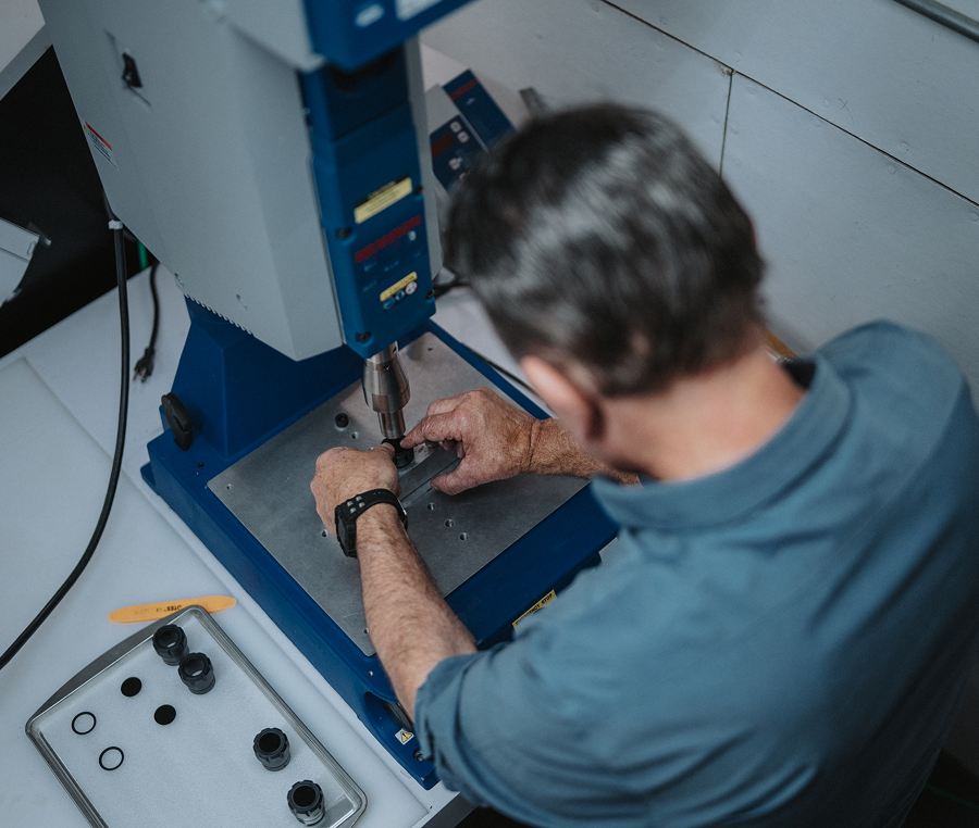 Person operating a blue industrial machine.