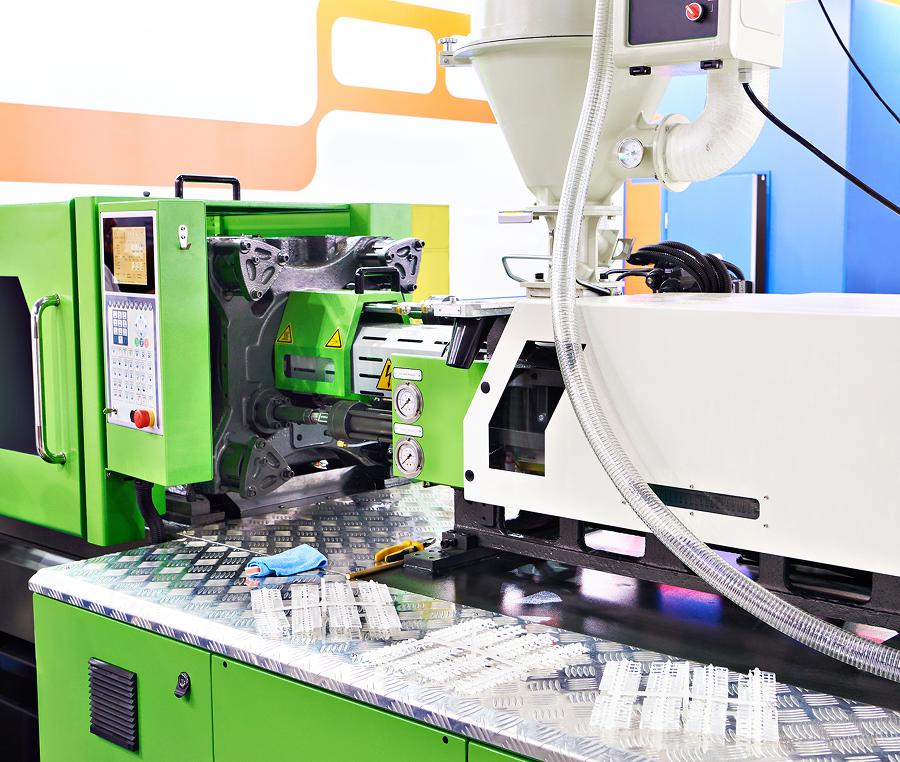 Plastic injection molding machine in operation.